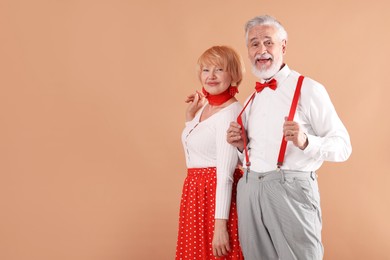 Photo of Lovely senior couple together on light brown background, space for text