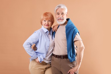 Photo of Lovely senior couple together on light brown background