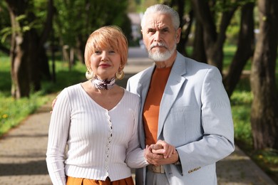 Photo of Lovely senior couple spending time together in park