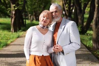 Photo of Lovely senior couple spending time together in park