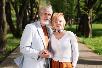 Photo of Lovely senior couple spending time together in park