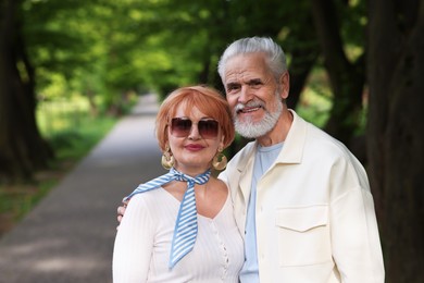 Photo of Lovely senior couple spending time together in park