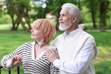 Photo of Lovely senior couple spending time together in park