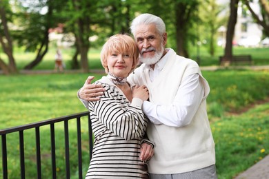Photo of Lovely senior couple spending time together in park