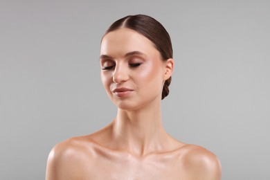 Photo of Portrait of beautiful young woman on gray background