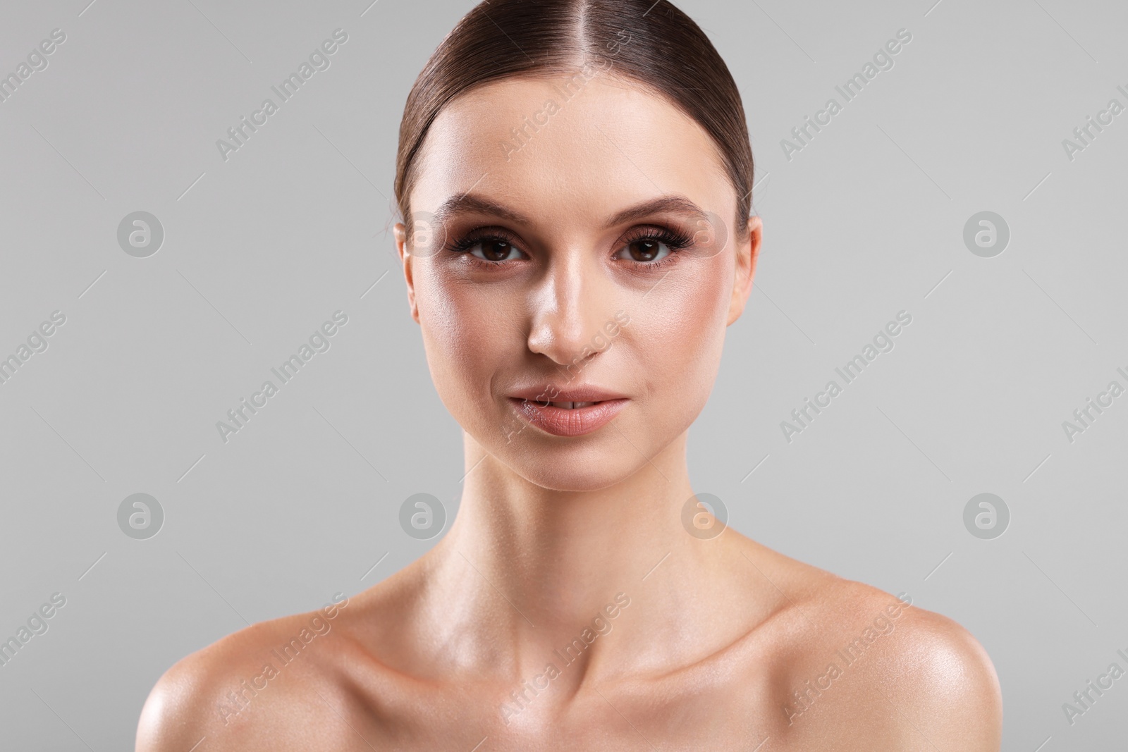 Portrait of beautiful young woman on gray background Photo of Portrait of beautiful young woman on gray background