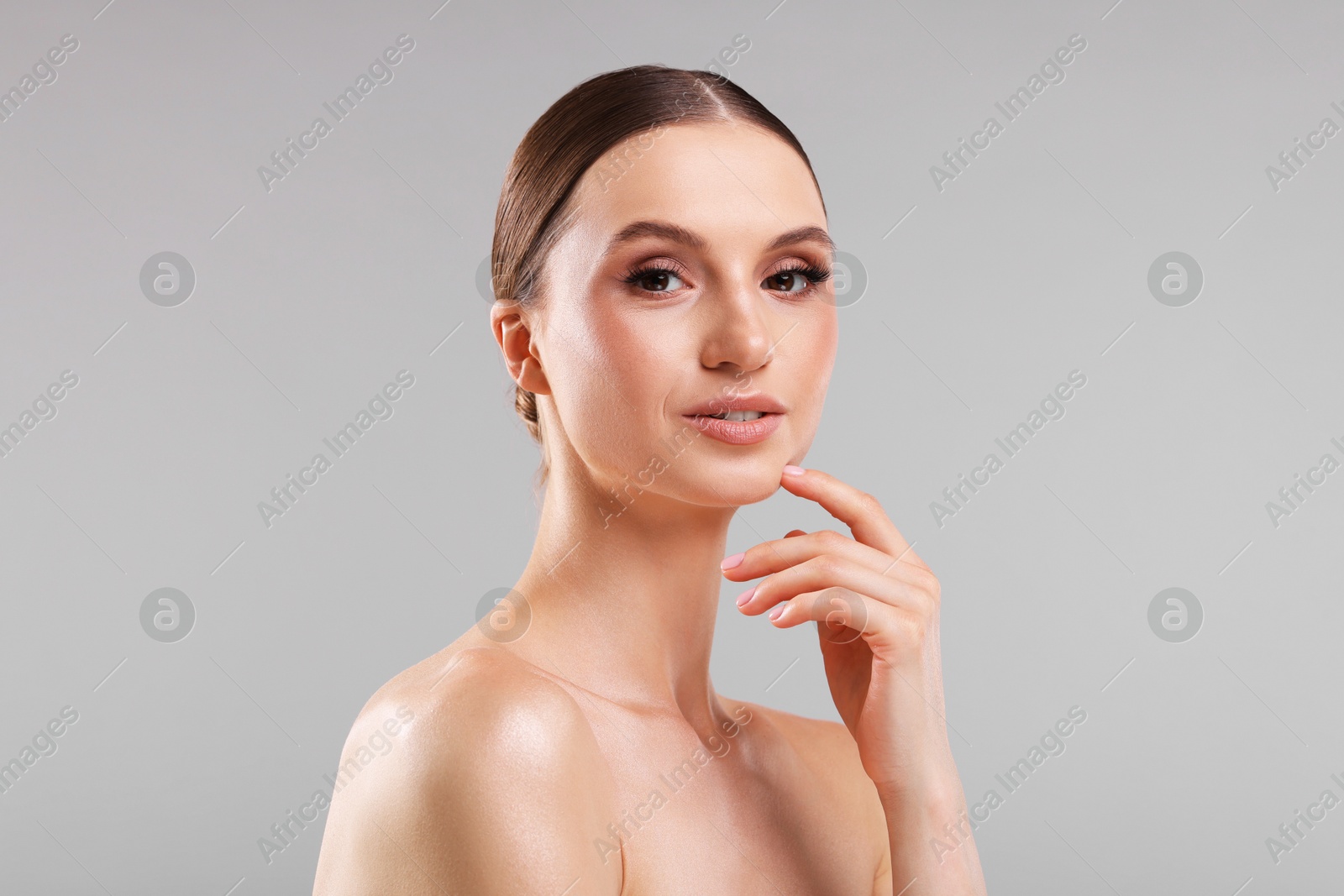 Portrait of beautiful young woman on gray background Photo of Portrait of beautiful young woman on gray background