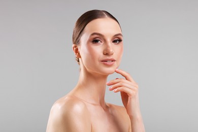 Photo of Portrait of beautiful young woman on gray background