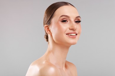 Photo of Portrait of beautiful young woman on gray background