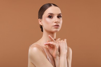 Photo of Portrait of beautiful young woman on beige background