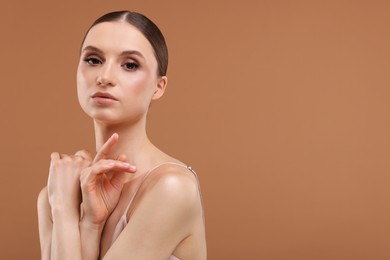 Photo of Portrait of beautiful young woman on beige background, space for text