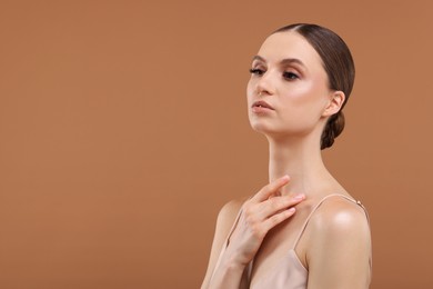 Photo of Portrait of beautiful young woman on beige background, space for text