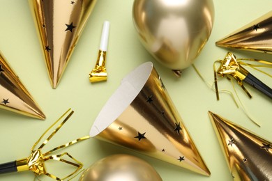 Photo of Flat lay composition with party hats on light green background