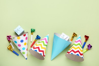 Photo of Flat lay composition with party hats on light green background. Space for text