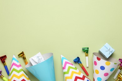 Photo of Flat lay composition with party hats on light green background. Space for text