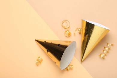 Photo of Party hats and streamers on color background, flat lay. Space for text