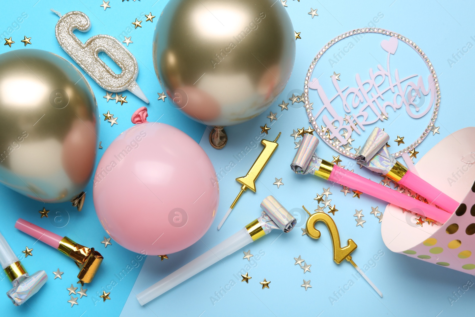 Flat lay composition with party hat and balloons on light blue background Photo of Flat lay composition with party hat and balloons on light blue background