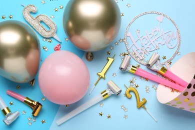 Photo of Flat lay composition with party hat and balloons on light blue background