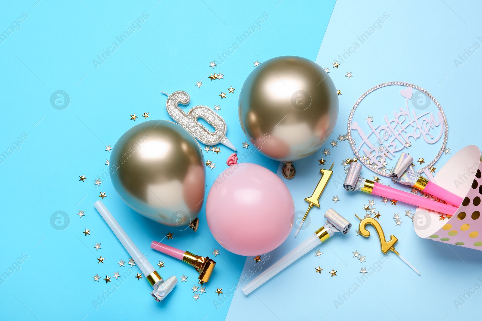 Flat lay composition with party hat and balloons on light blue background Photo of Flat lay composition with party hat and balloons on light blue background