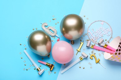Photo of Flat lay composition with party hat and balloons on light blue background