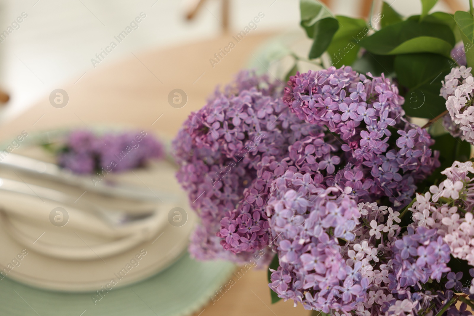 Beautiful lilac flowers on table, closeup. Space for text Photo of Beautiful lilac flowers on table, closeup. Space for text