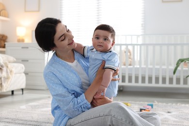 Photo of Mother with her cute baby at home