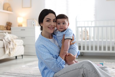 Photo of Mother with her cute baby at home
