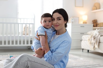 Photo of Mother with her cute baby at home