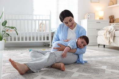 Photo of Mother with her cute baby at home