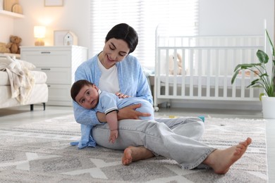 Photo of Mother with her cute baby at home