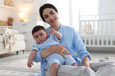 Photo of Mother with her cute baby at home