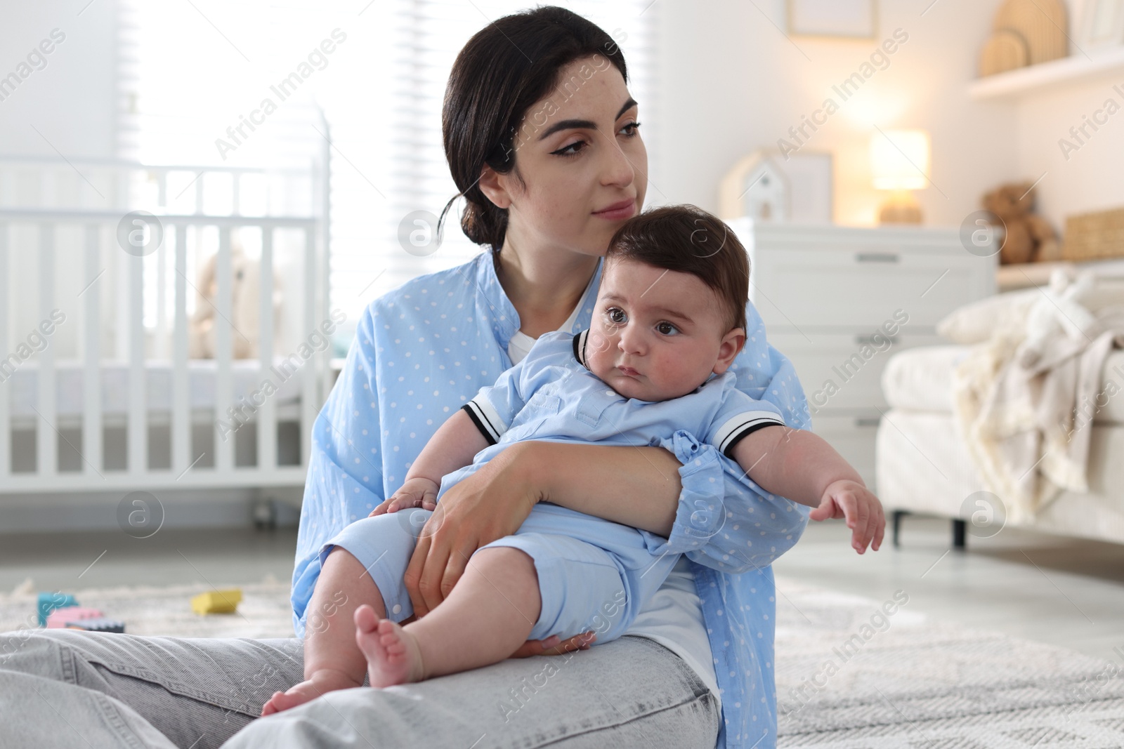 Woman suffering from postpartum depression with her little baby at home Photo of Woman suffering from postpartum depression with her little baby at home
