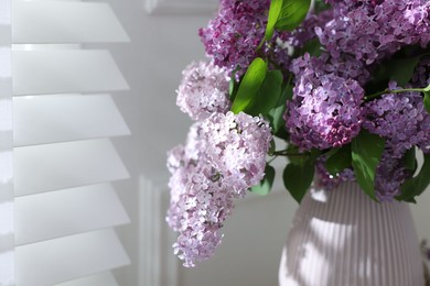 Photo of Bouquet of beautiful lilac flowers indoors, closeup. Space for text