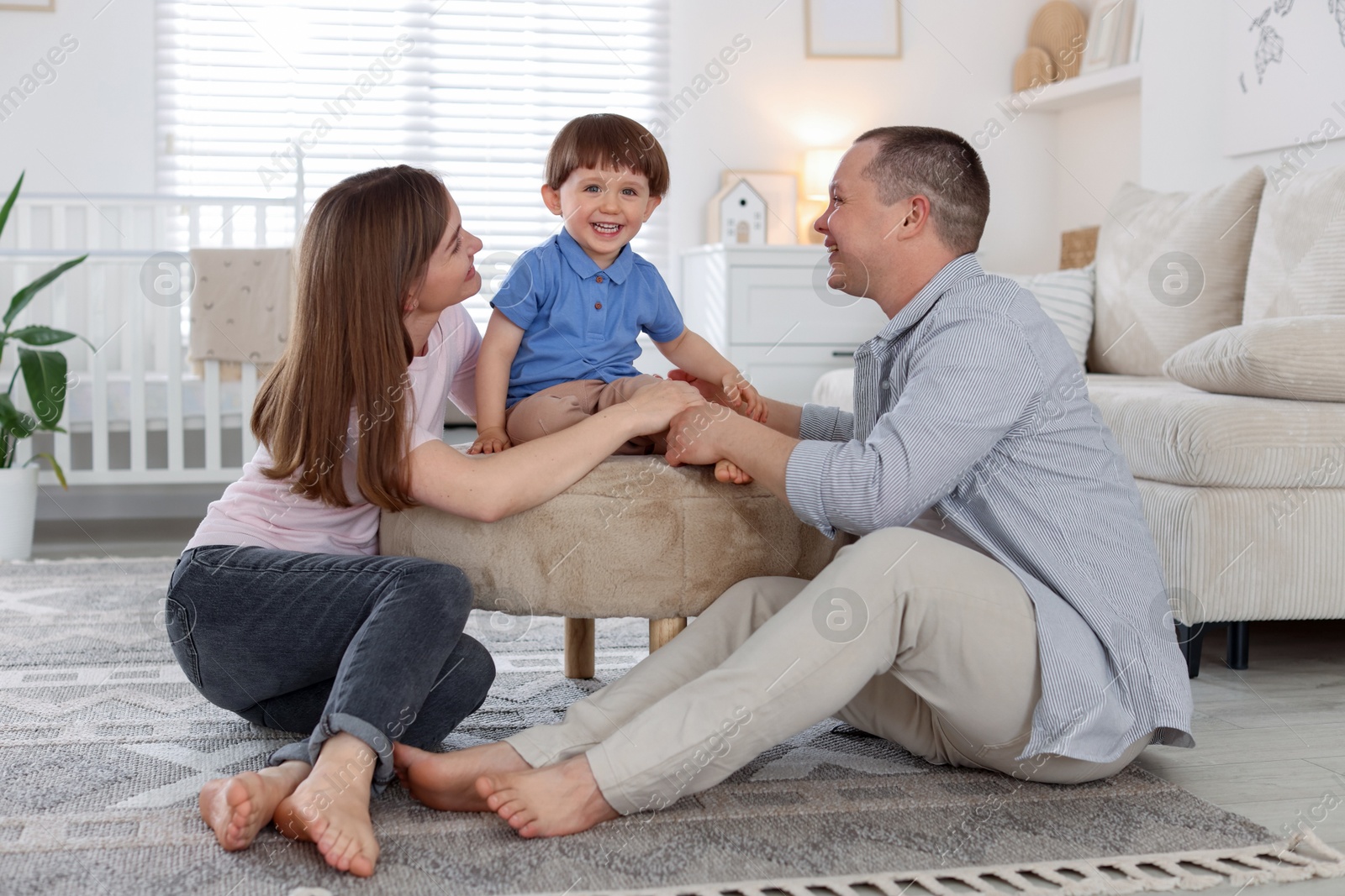 Cute little boy and his parents at home. Lovely family Photo of Cute little boy and his parents at home. Lovely family