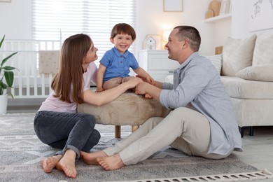 Photo of Cute little boy and his parents at home. Lovely family