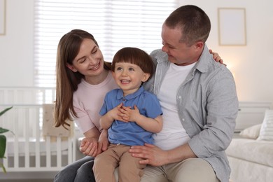 Photo of Cute little boy and his parents at home. Lovely family