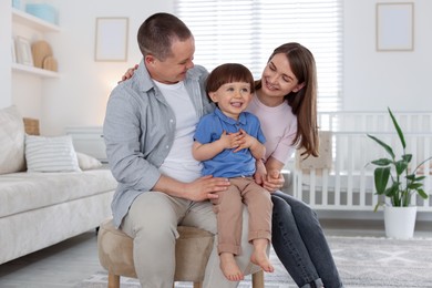 Photo of Cute little boy and his parents at home. Lovely family