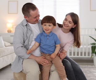 Photo of Cute little boy and his parents at home. Lovely family