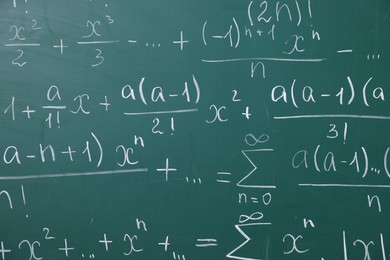 Photo of Different formulas written with chalk on blackboard