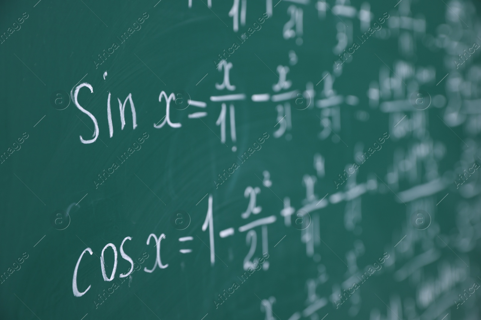 Different formulas written with chalk on blackboard, closeup Photo of Different formulas written with chalk on blackboard, closeup