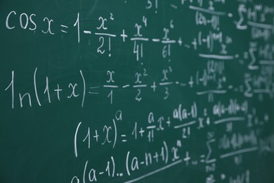 Photo of Different formulas written with chalk on blackboard, closeup