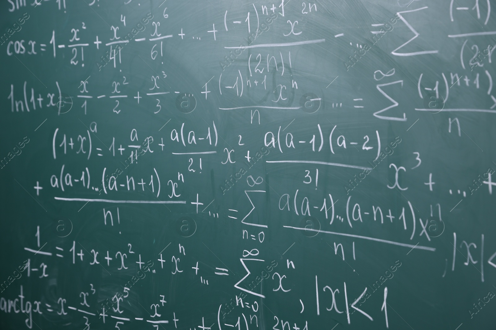 Different formulas written with chalk on blackboard Photo of Different formulas written with chalk on blackboard