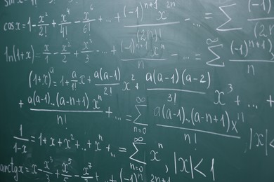 Photo of Different formulas written with chalk on blackboard
