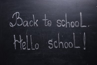 Photo of Phrases Back To School and Hello School with exclamation mark on blackboard