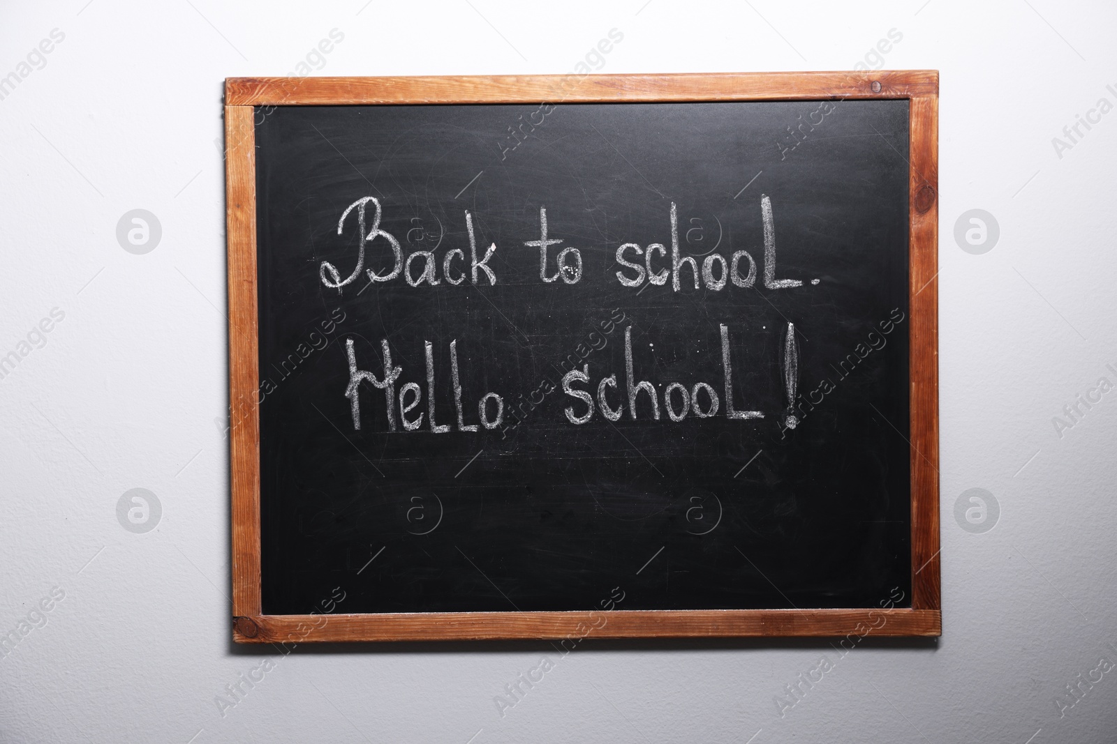 Phrases Back To School and Hello School with exclamation mark on blackboard Photo of Phrases Back To School and Hello School with exclamation mark on blackboard