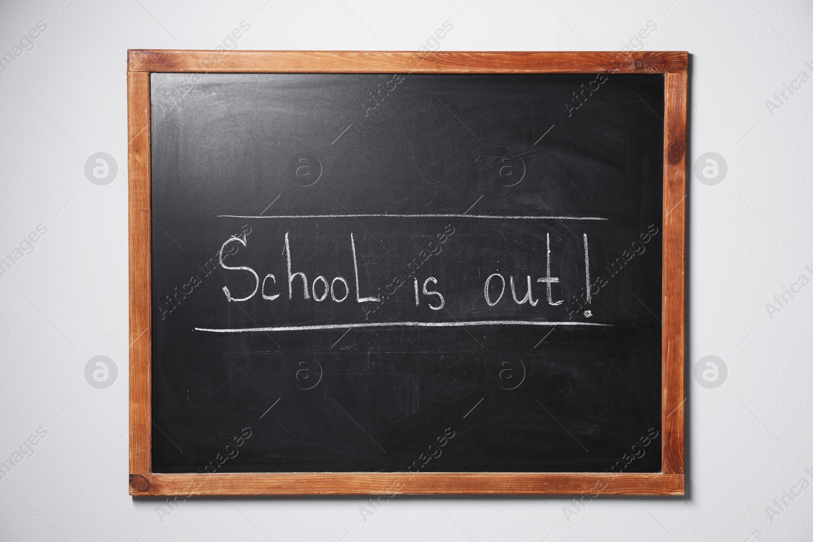 Phrase School's Out with exclamation mark on blackboard Photo of Phrase School's Out with exclamation mark on blackboard