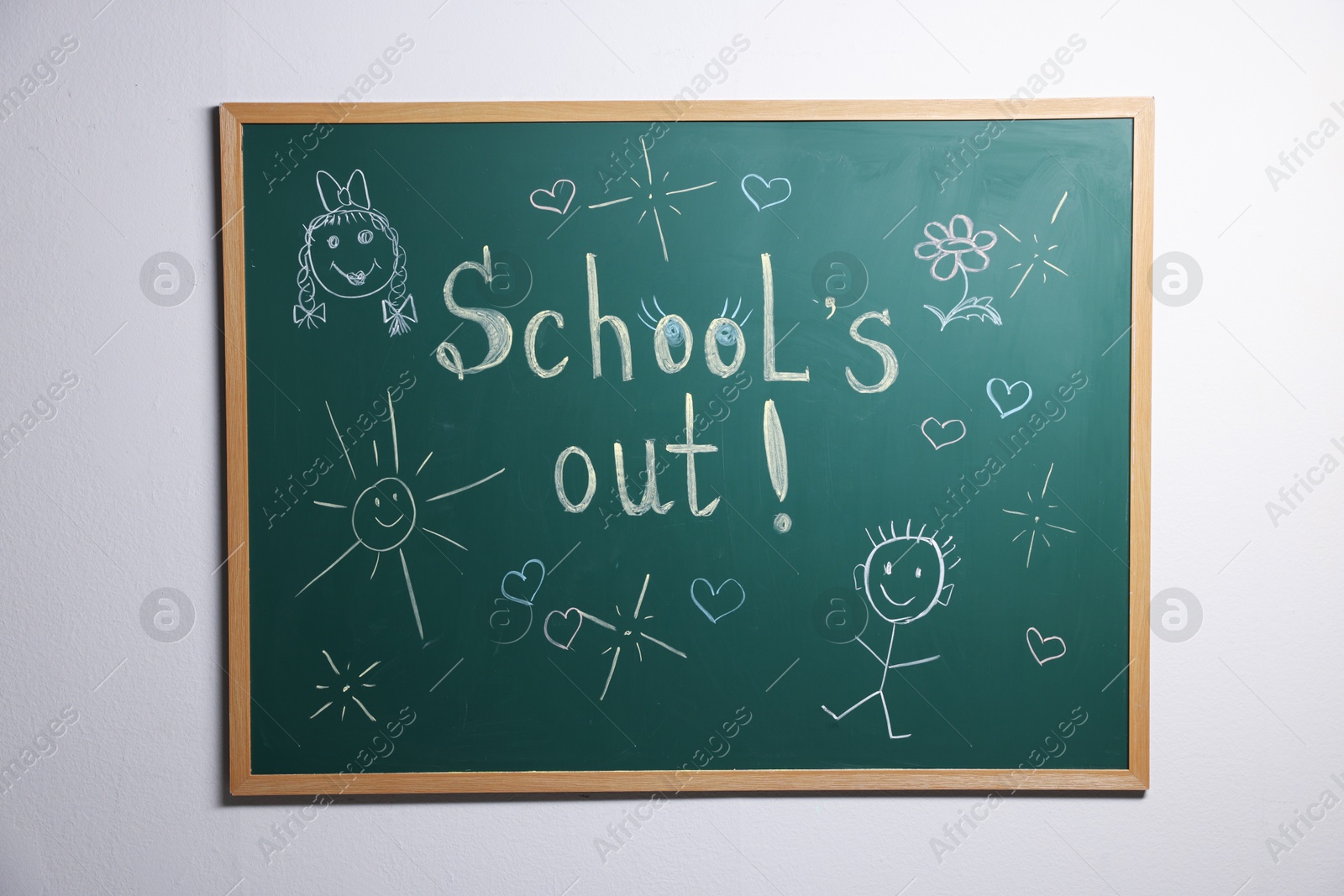 Phrase School's Out with exclamation mark and different drawings on blackboard Photo of Phrase School's Out with exclamation mark and different drawings on blackboard