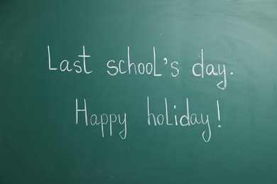 Photo of Phrases Last School's Day and Happy Holiday with exclamation mark on blackboard