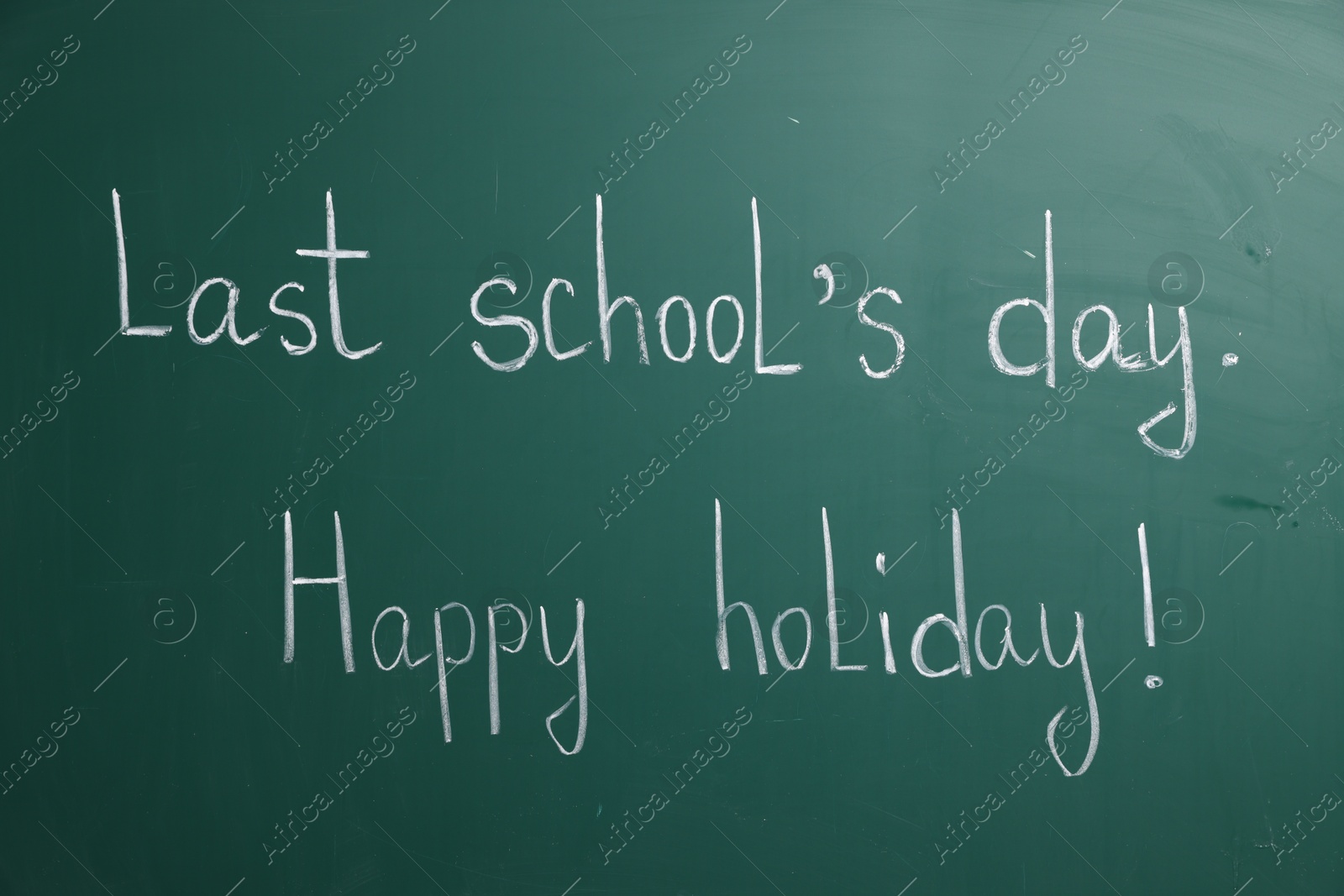 Phrases Last School's Day and Happy Holiday with exclamation mark on blackboard Photo of Phrases Last School's Day and Happy Holiday with exclamation mark on blackboard