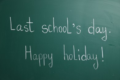 Photo of Phrases Last School's Day and Happy Holiday with exclamation mark on blackboard